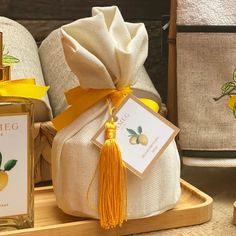 a bottle of perfume sitting on top of a wooden tray next to towels and other items