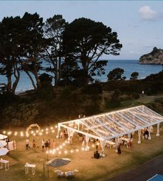 an aerial view of a wedding reception at dusk with string lights strung from the ceiling