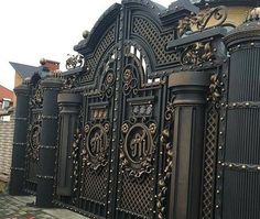 an ornate iron gate on the side of a building