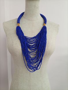 African wedding necklace, Zulu necklace, Beaded shawl necklace, African jewelry, Masai necklace, Bridesmaid necklace, Wedding gift This stunning necklace is superbly crafted with fine beads. The necklace can be worn with any outfit at different occasions and it will absolutely make you stand out. 100% handmade using fine beads. Closure: hook Color: Royal blue dotted with copper. Different colors are available. Please send us a convo 3-5 days delivery via DHL Express The shipping fee is for the f Blue Beaded Necklaces With Tiny Beads For Party, Blue Beaded Necklace With Tiny Beads For Party, Blue Beaded Necklace For Party, Blue Party Beaded Necklace With Tiny Beads, Traditional Blue Beaded Necklaces For Party, Blue Beaded Bridal Necklace With Round Beads, Blue Beaded Bridal Necklace For Party, Blue Beaded Chain Bib Necklaces, Blue Beaded Chain Bib Necklace With Round Beads