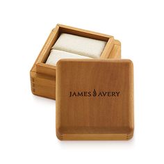 a wooden box with two pieces of paper in it and the words james avery written on them