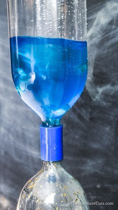 a blue liquid in a wine glass sitting on top of a table