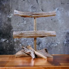 a piece of driftwood sitting on top of a wooden table next to a wall