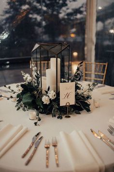 the table is set with candles, flowers and napkins for an elegant wedding reception