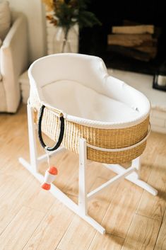 a baby bassinet sitting on top of a wooden floor