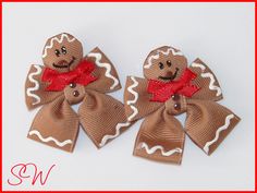 two gingerbread man hair clips with red bows