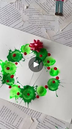 the paper is made to look like a wreath with green and red decorations on it