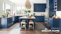 a kitchen with blue cabinets and wooden floors