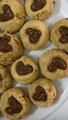 chocolate chip cookies on a white plate with hearts in the middle and melted chocolate inside