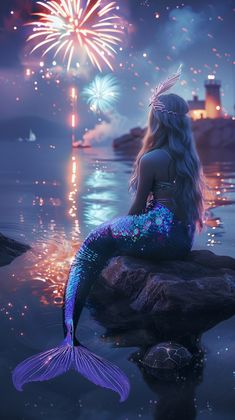 a mermaid sitting on top of a rock next to a firework in the sky