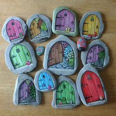 painted rocks with different colored doors on them