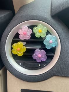 colorful flowers are placed on the center console of a car's steering wheel cover