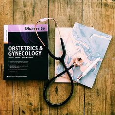 a pair of scissors sitting on top of a book next to a stethoscope