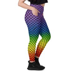 a woman wearing colorful leggings with fish scales on the side and black top