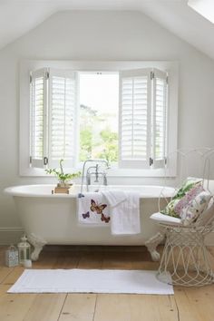 a white bath tub sitting next to a window