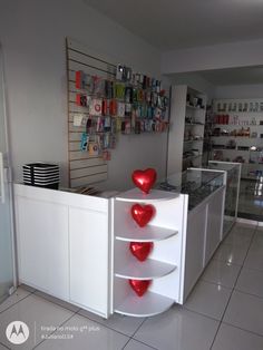 a white counter with three red hearts on it