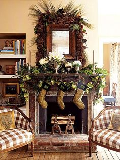 a living room filled with furniture and a fire place covered in christmas stockings next to a fireplace