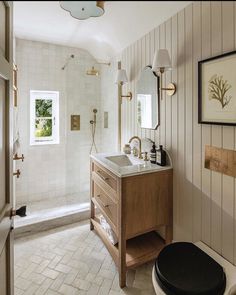 a bathroom with a toilet, sink and mirror