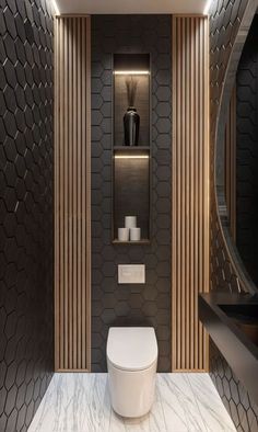 a modern bathroom with black and white tiles on the walls, wood paneling around the toilet