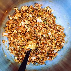 a blue bowl filled with food and a black spatula in the bottom left corner