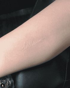 a person with a tattoo on their arm that reads,'baltimore'in cursive writing