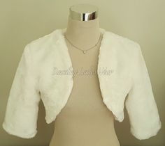 "All of our items are handmade and unique to our company.  Soft faux Fur shrugs with 3/4 length sleeves, available in ivory and black. These stunning boleros are luxuriously soft and are fully lined with a matching satin lining. They are finished to a high standard. Perfect to finish the look! Available in black, ivory, grey and navy Lots of other styles/colours available, click on link below to view my Etsy shop -  https://www.etsy.com/uk/shop/dazzlingladieswear?ref=hdr_shop_menu Approximate measurements/sizes - XS - UK 4-6 / US 1-2 / Europe 32 -34 Shoulders - 15\" / 38cm - To fit chest 30\" - 33\" / 76cm - 84cm S - UK 8-10 / US 4-6 / Europe 36-38 Shoulders - 16\" / 40.5cm - To fit chest 33\" - 36\" / 84cm - 91.5cm M - UK 12-14 / US 8-10 / Europe 40-42 Shoulders - 17\" / 43cm - To fit che Bolero Sleeves, Shoulder Shrug, Bolero Jacket Wedding, Faux Fur Bolero, Faux Fur Wedding, Fur Bolero, Shrug Jacket, Faux Fur Shrug, Fur Shrug