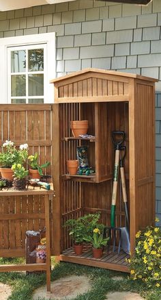 a garden shed with plants and gardening tools in it