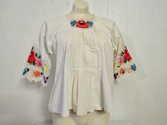 "Vintage 1950s (maybe earlier) white cotton shirt or peasant blouse. Has lace and embroidered half sleeves and a snap front. Hippy flower child style. Size medium/large, or one size fits all. Actual measurements are: 43\" at the bust 54\" at the waist 22\" overall length In very good condition." Bohemian Broderie Anglaise Short Sleeve Blouse, Bohemian Blouse With Broderie Anglaise Short Sleeves, White Cotton Cottagecore Peasant Top, Cottagecore White Cotton Peasant Top, Vintage Cotton Peasant Top For Spring, Spring Peasant Top With Yoke Detail, Spring Peasant Top With Yoke, Vintage White Blouse For Spring, Fitted White Folk Peasant Top