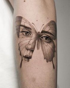 a woman's face with a butterfly tattoo on her arm