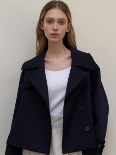 This is a clean and casual trench jacket by L’oiE that is made out of high quality and sturdy fabric. With unique design detail and trendy mood, you can style it for your refined and casual daily outfit.- Unique short length- Vent detail on the back and button detail- Modern and sophisticated look Chic Navy Outerwear With Lapel Collar, Navy Double-breasted Outerwear For Office, Navy Lapel Collar Outerwear For Office, Chic Lapel Collar Peacoat For Fall, Chic Peacoat With Lapel Collar, Navy Lapel Collar Outerwear For Fall, Navy Collared Outerwear For Work, Navy Outerwear With Lapel Collar For Fall, Navy Outerwear With Lapel Collar For Work