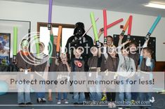 a group of children standing next to each other in front of a star wars poster