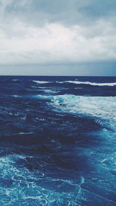 the ocean is blue and choppy with waves