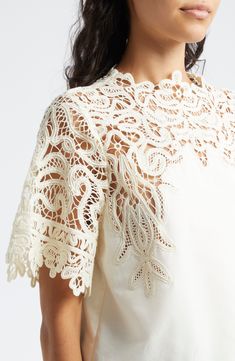 A graceful swirling pattern in guipure lace comprises the yoke and sleeves of this elegant cotton-and-silk top. 22" length (size 8) Back keyhole with button-and-loop closure Jewel neck Short sleeves 70% cotton, 30% silk Dry clean Imported Elegant Cotton Lace Top, Elegant Summer Lace Top In Cotton Lace, Elegant Cotton Lace Top For Summer, Elegant Summer Cotton Lace Top, Elegant Lace Patchwork Top For Spring, Elegant Spring Lace Patchwork Top, Spring Formal Lace Patchwork Top, Chic Cotton Lace Top, Elegant Cotton Lace Patchwork Tops