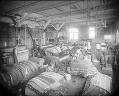 an old factory filled with lots of different types of fabrics and other things in the room