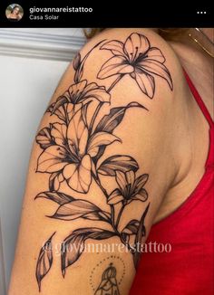 a woman's arm with flowers on it and a star in the middle,