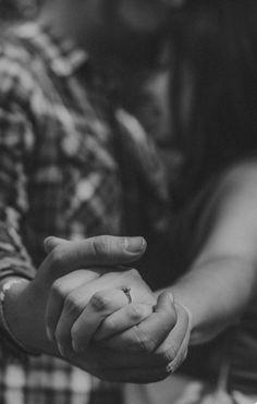 black and white photo of couple holding hands