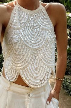 Cleo White Sequin Halter Tie Top – 12th Tribe Sparkling Top Outfit, Disco Theme Bachelorette Party Outfits, Glamorous Summer Wedding Tops, Chic Sequined Tops For Wedding, White Sequined Tops For Spring, Spring White Sequined Tops, White Embellished Tops For Festive Occasions, White Sequined Party Top, White Sequined Tops For Night Out