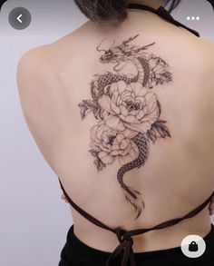 a woman with a dragon tattoo on her back