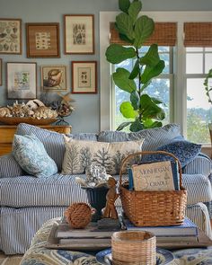 a living room filled with furniture and lots of pictures hanging on the wall above it