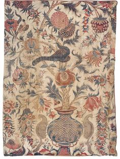 an antique rug with birds and flowers on it's border, in the shape of a vase