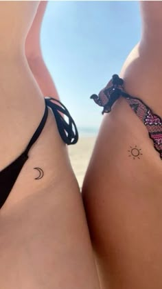 two women's butts with tattoos on them, one has a sun and the other is a moon