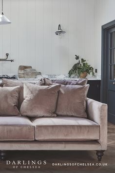 a couch with pillows on it in a living room