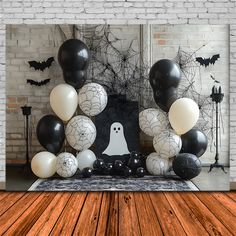 a room decorated for halloween with black and white balloons