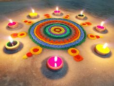 there are many lit candles in the middle of this circular design on the ground,