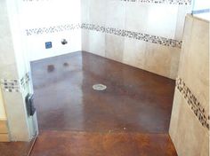 an empty bathroom with tile walls and flooring in the shower area, next to a toilet