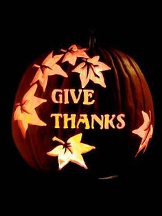 a carved pumpkin with the words give thanks written on it and stars in the center