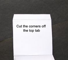 a close up of an open box with the words cut the corners off the top tab