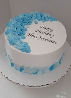 a white cake with blue frosting and flowers on the top that says happy birthday hea jeremas