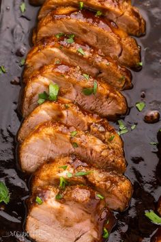 sliced pork with sauce and parsley on top