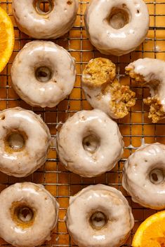 glazed donuts and orange slices on a cooling rack